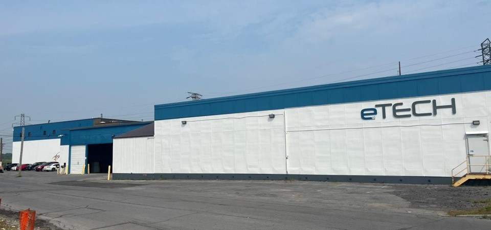 eTECH warehouse exterior showcases a large, modern facility against a clear blue sky.